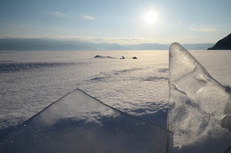 Thin transparent ice floes against the sunset light. Hummocks on Baikalの写真素材