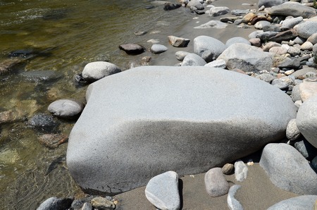 Big smooth stone on the shore of Irkut River in the Sayan Mountains, Buryatiaの写真素材