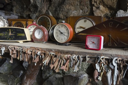 The collection of retro alarms on shelv and old rusty keysの写真素材