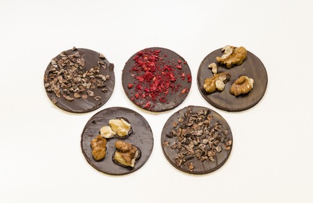 Chocolate medals with different crumbs. Sweet presentの写真素材