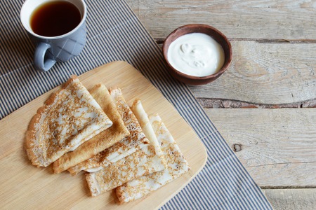 Russian-style pancakes pancakes and tea on old wooden background. Empty space. Maslenitsaの写真素材