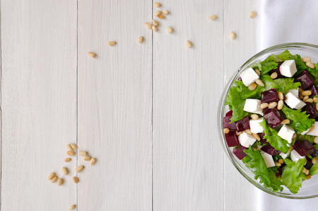 Salad of Beetroot, Feta cheese and lettuce leaves with pine nuts. Empty spaceの写真素材