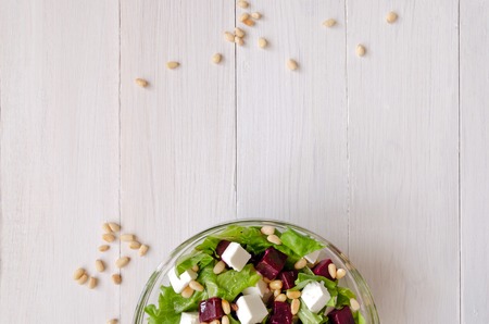Salad of Beetroot, Feta cheese and lettuce leaves with pine nuts. Empty spaceの写真素材