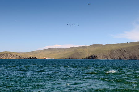 Olkhon Island coast with ferry port. Lake Baikal. View from the waterの写真素材