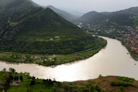 Top view on confluence of Aragvi and Kura rivers and Mtskheta - ancient capital of Georgia with...