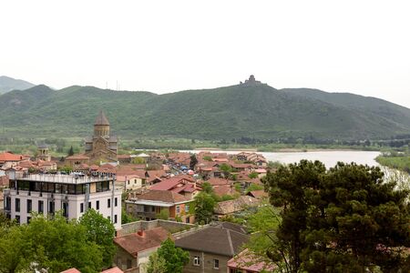Mtskheta - ancient capital of Georgia. Top view of old town with Jvari Monastery Hill and...