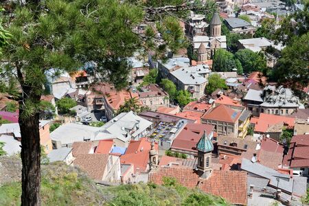 Top view on Old Tbilisi with red tiled roofs at sunny day, Georgia