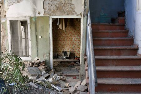 Remains of apartment in destroyed residential building. Demolition of housing for new construction