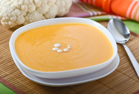 Vegetable soup in a plate with cauliflower, carrots, potatoes and onionsの写真素材