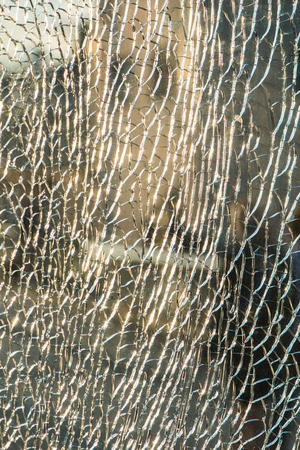 Broken pattern on glass stand. Sun rays are refracted and reflected on broken glass