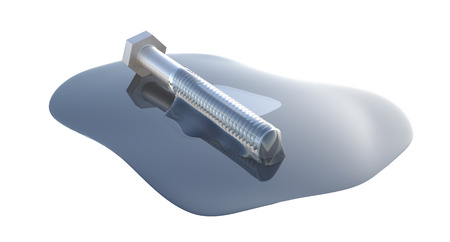 Isolated image of a bolt being in a puddle of motor oilの写真素材