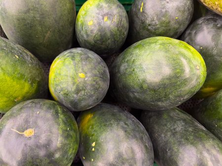 Close-up of Fresh Watermelons Displayed in Market Stallの写真素材