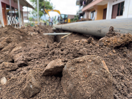 Urban construction site with heavy machinery and soil excavationの写真素材