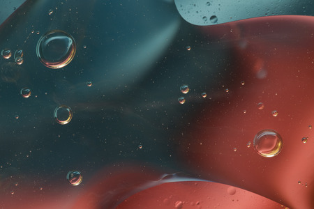 Abstract pattern of colored oil bubbles on waterの写真素材