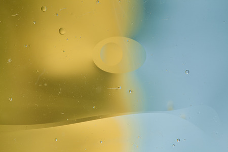 Abstract pattern of colored oil bubbles on water