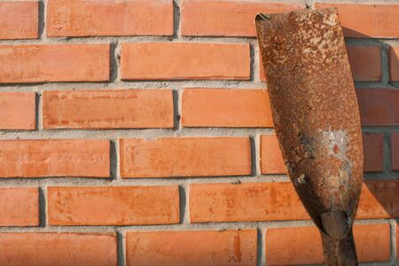 spade shovel on red brick wallの写真素材