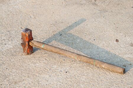 wood stick Sledge Hammer on the groundの写真素材