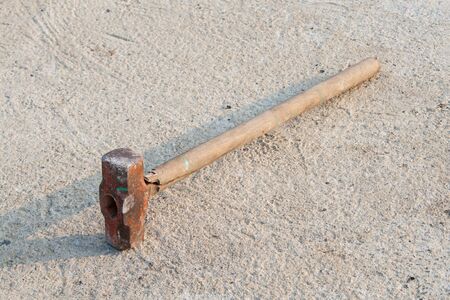 wood stick Sledge Hammer on the groundの写真素材