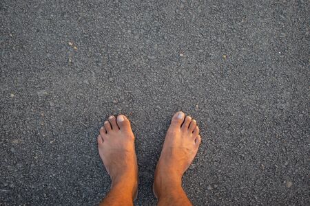 bare foot on Asphalt roadの写真素材