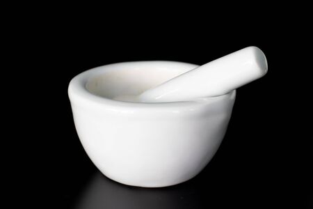 isolated white medicine mortar on dark backgroundの写真素材