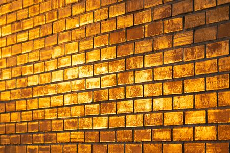 golden color of brick wall in twilight timeの写真素材