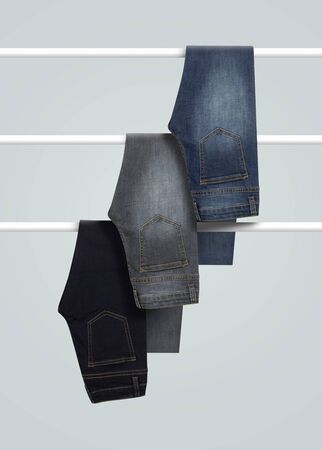 set of Men jeans hanging isolated on white backgroundの写真素材