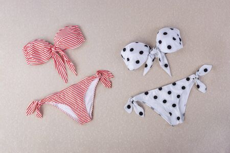 red and white striped sita bikini and black and white polka dot bikini isolated on textured backgroundの写真素材