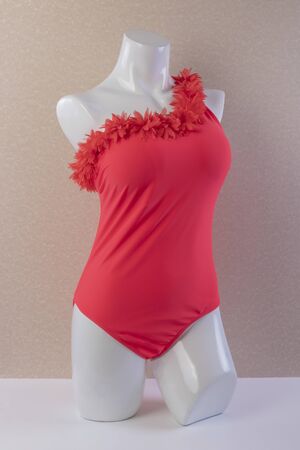 Beautiful One-Shoulder Top one piece trendy red sexy swimsuit on mannequin on textured background front viewの写真素材