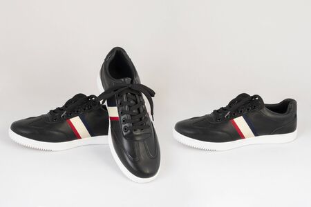 black leather striped sneakers shoes isolated on white background side and front viewの写真素材