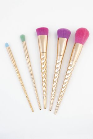 Unicorn themed makeup brush set on a white background.の写真素材