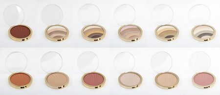 big set of Face Cosmetic Makeup Powder blusher and eyeshadow in gold Round Plastic Case on White Backgroundの写真素材