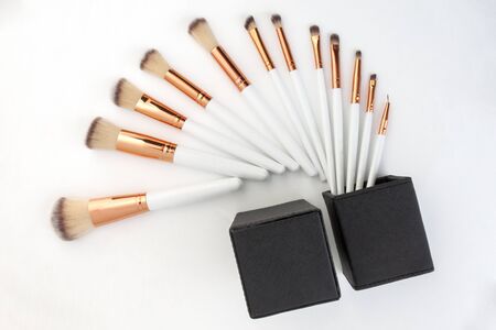 set of make-up brushes, shot on white background grouped together and counterbalanced by a larger powder brushの写真素材