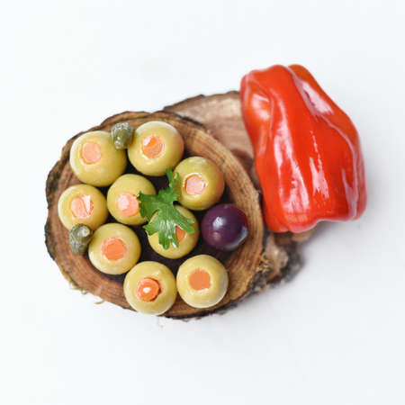 Pickled olives, cucumber and pepper on whiteの写真素材