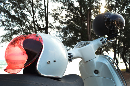white helmet on white classic scooter.の写真素材