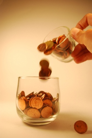 dip coin from one galss into one glassの写真素材