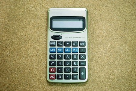 one gold calculator on wooden blankの写真素材