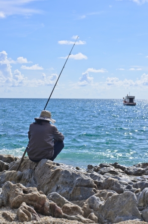 fisherman is waiting for fish at seaの写真素材