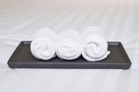 white roll towel on bedの写真素材