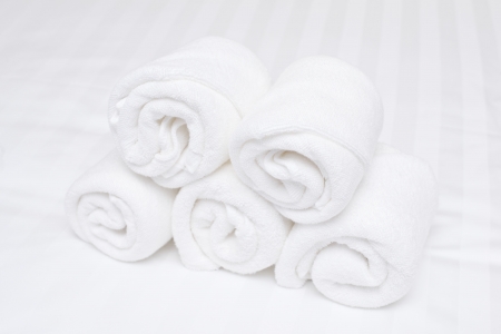 white roll towel on bedの写真素材