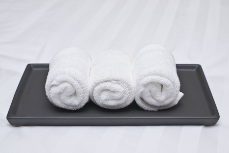 white roll towel on bedの写真素材