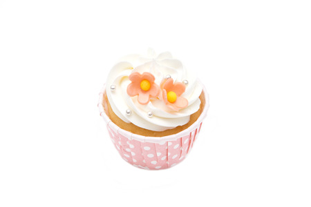 sweet cupcakes and whipped cream in pink cup isolated