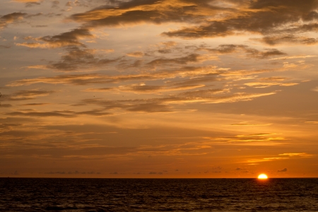 big sun on the water in sunset timeの写真素材