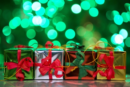 little gift boxes with green bokeh backgroundの写真素材