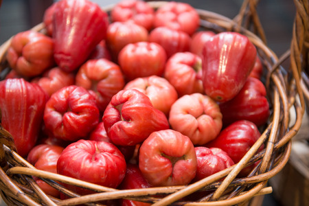 fresh rose apple in wood basket, fruitsの写真素材