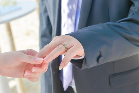 bride is wearing wedding ring to groom, ceremonyの写真素材