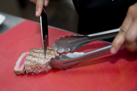 chef is slide grill tuna with knife, cookingの写真素材