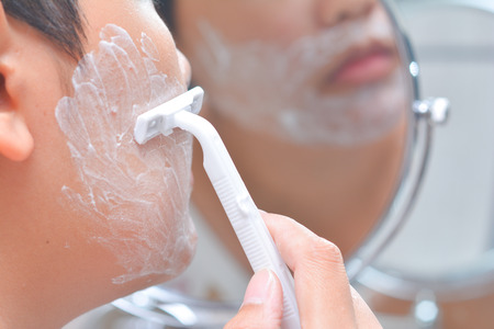 Man is shaving mustache, razorの写真素材