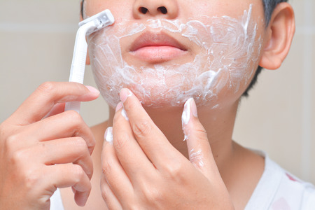 Man is shaving mustache, razorの写真素材