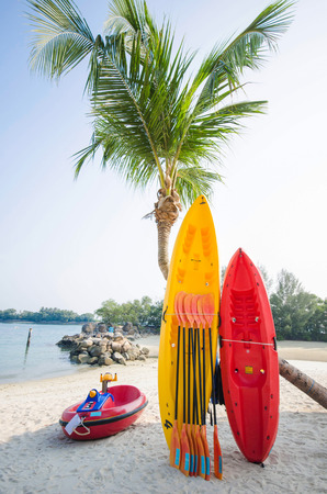 yellow and red canoeing on the beach, spotの写真素材