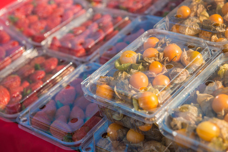persimmon and strawberry in plastic box, freshの写真素材